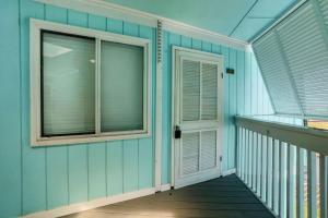 a balcony with a door and a window on a house at Beach Getaway w Pool & Private Balcony in Atlantic Beach +34 photos