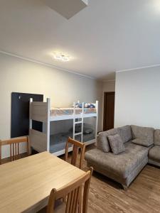 a living room with a couch and a bunk bed at Apartamente Shengjn in Shëngjin