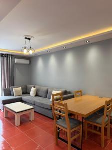 a living room with a couch and a table at Apartamente Shengjn in Shëngjin