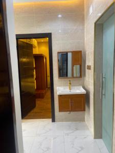 a bathroom with a sink and a mirror at شالية خاص in Khamis Mushayt +23 photos