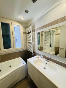 a bathroom with a tub and a sink and a mirror at San Marco Romantic Views in Venice +27 photos