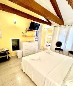 a bedroom with a white bed and a tv at San Marco Romantic Views in Venice