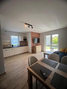 a living room with a couch and a table at Apartamenty Bursztynowe in Dębki