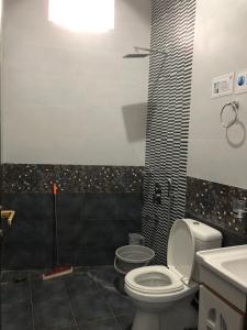 a bathroom with a toilet and a sink at 1 Bed Apartment in Murree in Murree