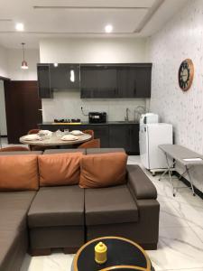a living room with a couch and a kitchen at 1 Bed Apartment in Murree in Murree +3 photos