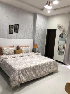 a bedroom with a large bed in a room at 1 Bed Apartment in Murree in Murree