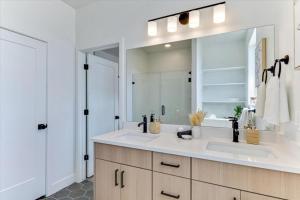 a bathroom with a sink and a large mirror at Stylish Pet Friendly Home for Work & Relaxation in American Fork +75 photos