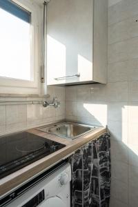 a kitchen with a sink and a stove at oasi relax Jacuzzi ultimo piano in Turin +7 photos