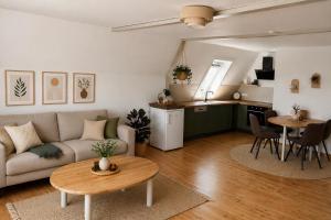 a living room with a couch and a table at Gästehaus Am Hafen 7 Glückstadt in Glückstadt +20 photos