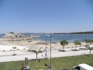 a view of a beach and a body of water at Pensión Chiquilla in O Grove
