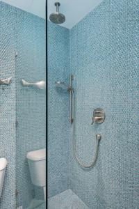 a bathroom with a shower with a glass door at Sunset Shores Sunset Shores 246 in Carpinteria +13 photos