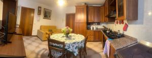 a kitchen with a table with a vase of flowers on it at Villa Linda in Schio