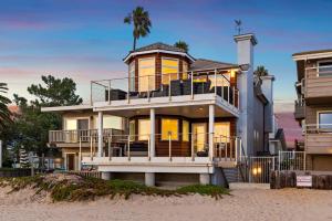 a house on the beach with a palm tree at Sandcastle in Carpinteria