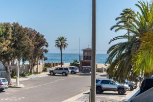 a parking lot with cars parked on the beach at Seaside Retreat at Solimar Sands in Carpinteria