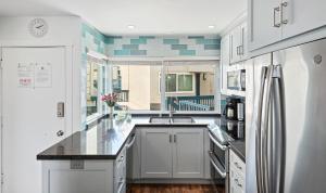 a kitchen with a sink and a counter top at Seaside Retreat at Solimar Sands in Carpinteria +25 photos