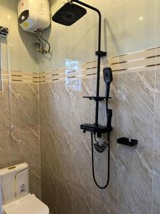 a shower in a bathroom with a toilet at ACCENT HOMES Apartment in Asaba