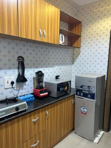 a kitchen with a stove and a refrigerator in it at ACCENT HOMES Apartment in Asaba