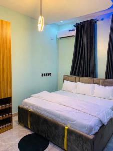 a bedroom with a large bed in a room at ACCENT HOMES Apartment in Asaba