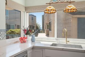 a kitchen with a sink and a large window at Sandbox at Solimar Sands in Carpinteria