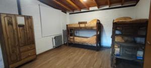a room with two bunk beds and a mirror at Ayün Mawida in Las Compuertas