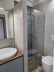 a bathroom with a shower and a sink and a toilet at Casa Vacanza Largo 65 in Scorrano