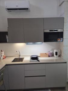 a kitchen with a sink and a counter top at Casa Vacanza Largo 65 in Scorrano