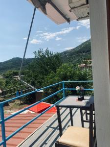 a balcony with a table and a view of a mountain at Olive Nest Bunec in Sasaj