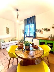 a living room with a table and yellow chairs at Podere al Fico B&B in Cecina +15 photos