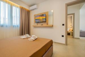 a hotel room with a bed with towels on it at Sunrise suites in Kallithea Halkidikis