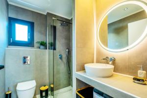 a bathroom with a sink and a shower at Sunrise suites in Kallithea Halkidikis +50 photos