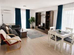 a living room with a couch and a table at Fly Airport Residences & Therme-SELF CHECK-IN in Otopeni