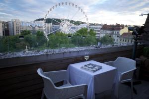 a table and chairs with a view of a ferris wheel at Vista Suites 1-2 in Budapest