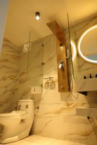 a bathroom with a toilet and a sink and a mirror at KarSa Woods, Kodaikanal in Perumālmalai