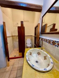 a bathroom with a sink and a toilet at Atelier Oaxaca in Oaxaca City