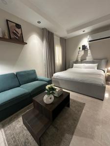 a hotel room with a bed and a couch at Clarance studio in Dhahran