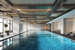 a swimming pool in a building with a large pool at Beijing Marriott Hotel Huairou in Huairou
