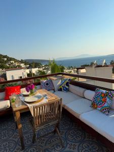 a couch sitting on top of a balcony with a table at Munahan Otel in Bodrum City