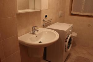 a bathroom with a sink and a toilet at Casa Monego in Fusine