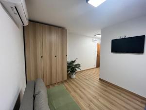 a living room with a couch and a flat screen tv at Apartament przy plaży in Zbąszyń