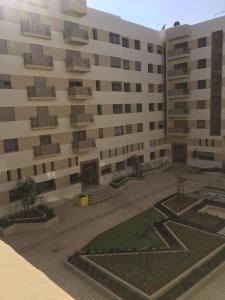 a large building with a courtyard in front of it at Sabirine in Derroua
