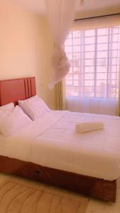 a bedroom with a bed with a dress on it at Moh airbnbs in Kisumu