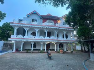a man on a motorcycle in front of a building at SN Villa in Jaffna