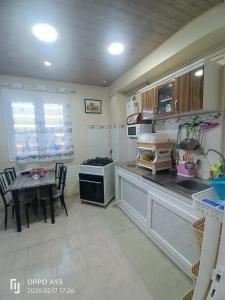 a kitchen with a table and a dining room at Appartement F3 équipé lux in Skikda
