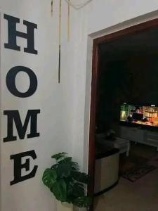 a living room with a potted plant next to a door at Appartement F3 équipé lux in Skikda
