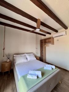 a bedroom with a bed with two pillows on it at Anogeio in Afitos