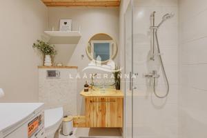 a bathroom with a shower and a sink and a mirror at Sweet apartament in Haapsalu +18 photos