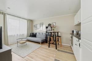 a living room with a couch and a table at Sweet apartament in Haapsalu