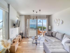 a living room with a couch and a table at Villa Elusia in Kefalos