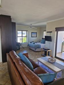 a living room with a couch and a bed at Beachway on Golden Mile in St. Helena Bay