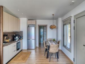 a kitchen with a table and chairs in a kitchen at Villa Elusia in Kefalos